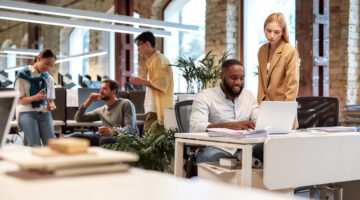 Young professionals. Group of multiracial business people working together in the creative co-working space. Team building concept. Office life.