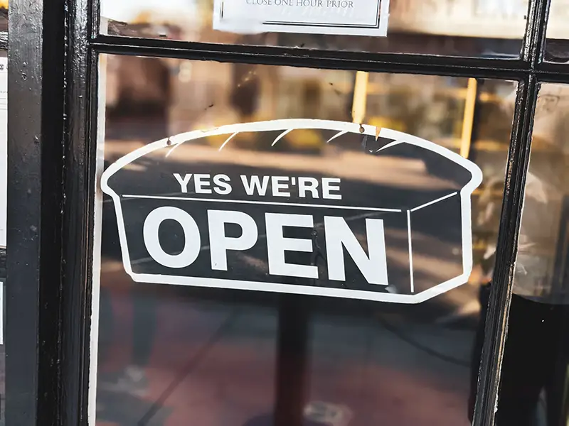 Open sign in shop premises window