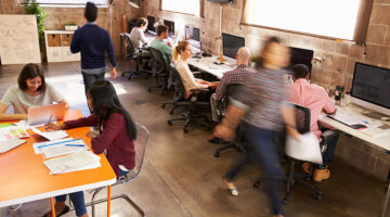 Elevated View Of Workers In Busy Modern Design Office