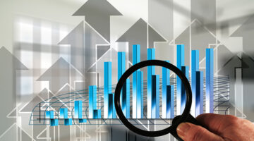 Magnifying glass and arrows growth hacking profit concept