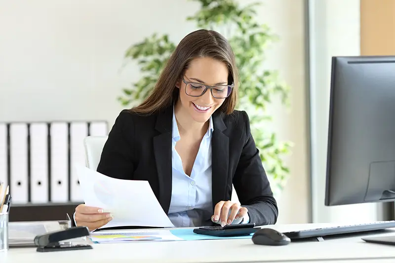 Businesswoman smiling while working on her desk