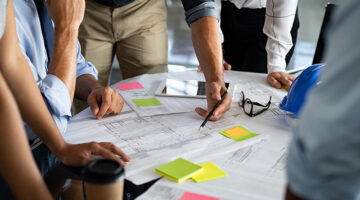 Architects discussing project on blueprint