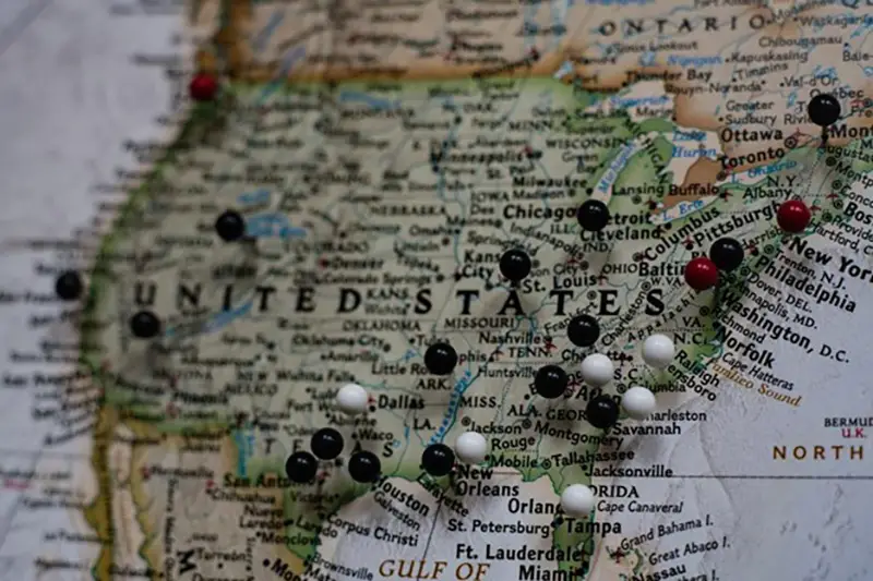 Map of the United States of America with lots of location pins stuck in it