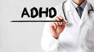 Doctor writing word ADHD with marker