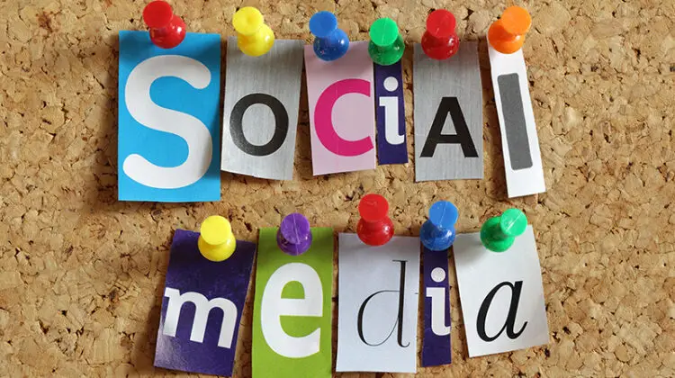 Social media from cutout newspaper headlines pinned to a cork bulletin board