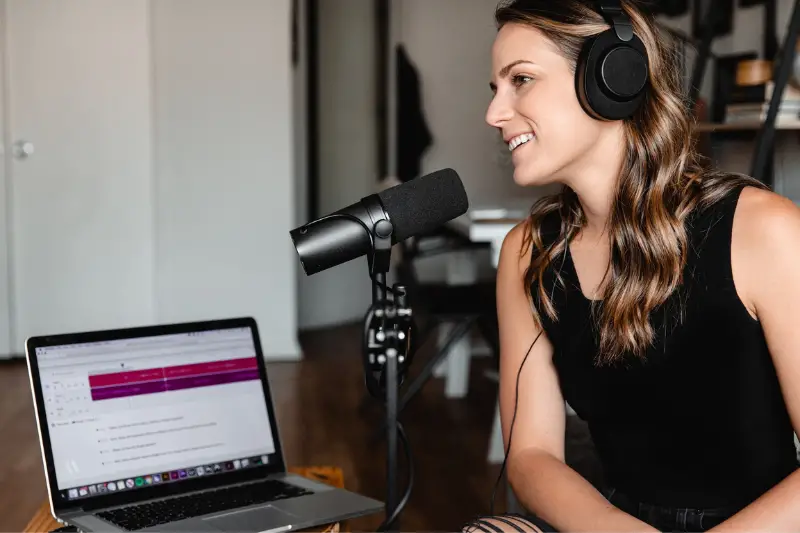 Woman sitting in front of microphone