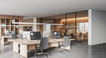 Corner of modern open space office with white and wooden walls, concrete floor and rows of computer tables. Meeting room in the background. 3d rendering