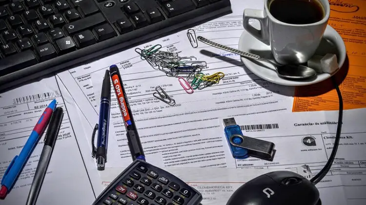 bookkeeper accountant - coffee cup on top of paperwork