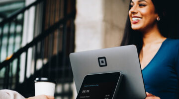 Woman smiling in front of her laptop