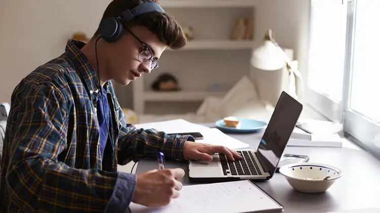 Young college boy doin his online study