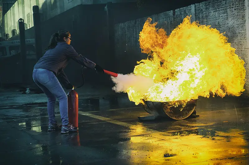 Woman holding fire extinguisher