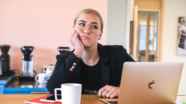 Woman bored and tired in fron t of her laptop
