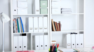 File folders, standing on the shelves in a home office