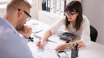 Financial Advisor Discussing Invoice With Her Client