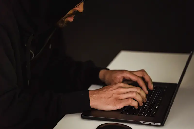 Programmer hacking data base on laptop