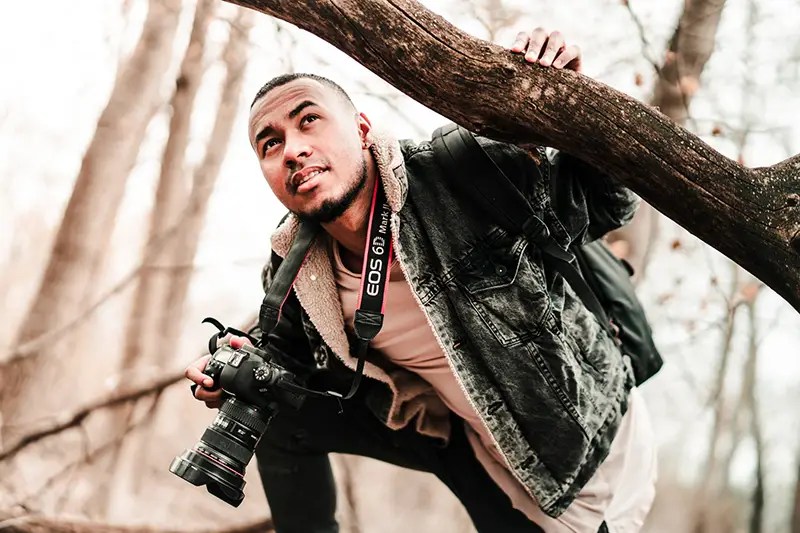 Freelance photographer in a tree taking creative images
