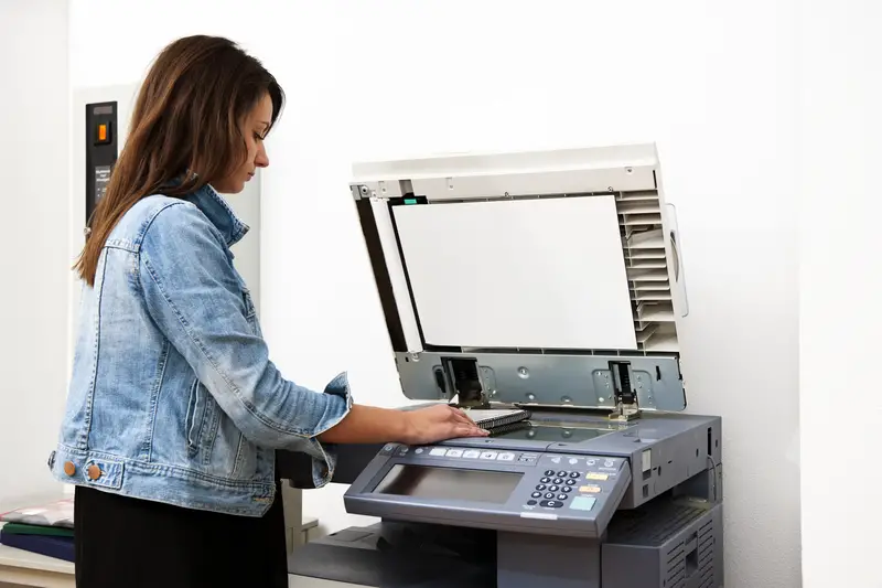 Woman copying notes on a coin operated photocopier