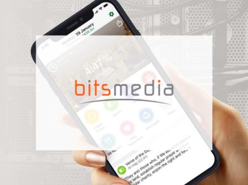 holding a phone with BitsMedia caption in front