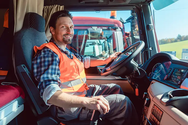 Lorry or truck driver sitting in the cabin of his vehicle