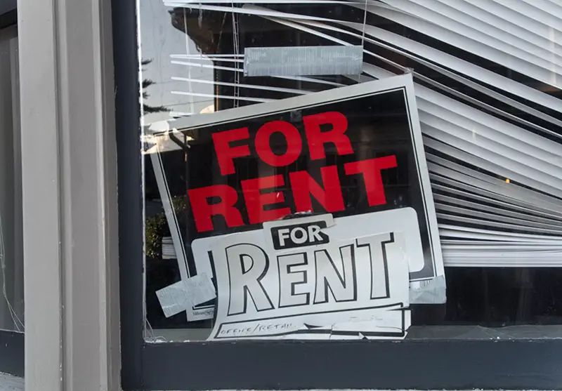 A `For Rent` sign in a window