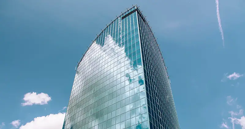 glass building with sky reflection