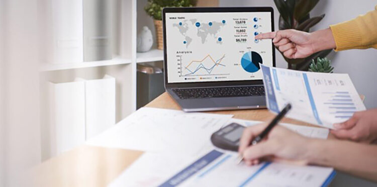 People working in laptop with graph and data