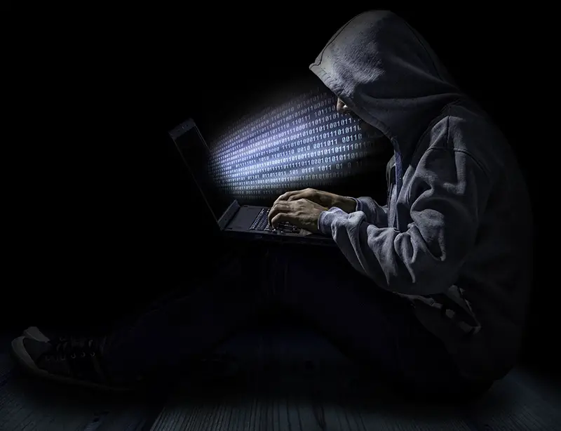 Cybersecurity hacker in dark gray hoodie
