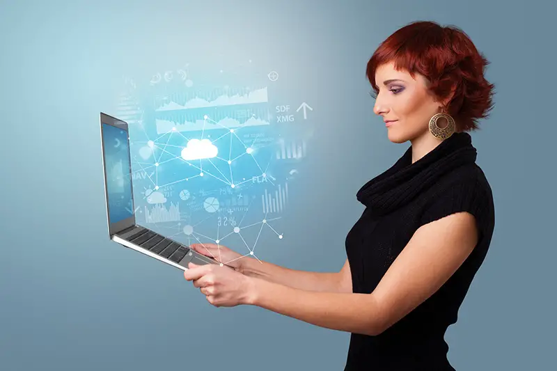 Woman holding laptop with cloud based system concept