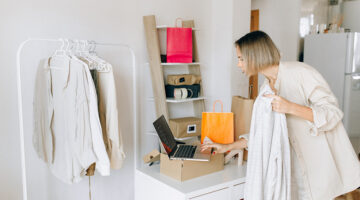 Woman in white dress standing in front of white wooden desk