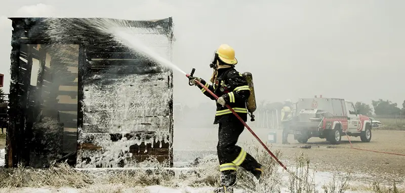 fireman extinguishes the burning house