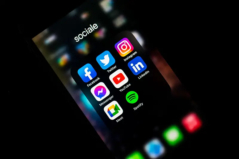 Mobile phone with social media apps on screen