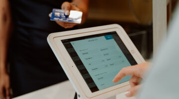 Cashier using POS software for receiving payment