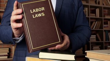 Attorney holding labor laws book