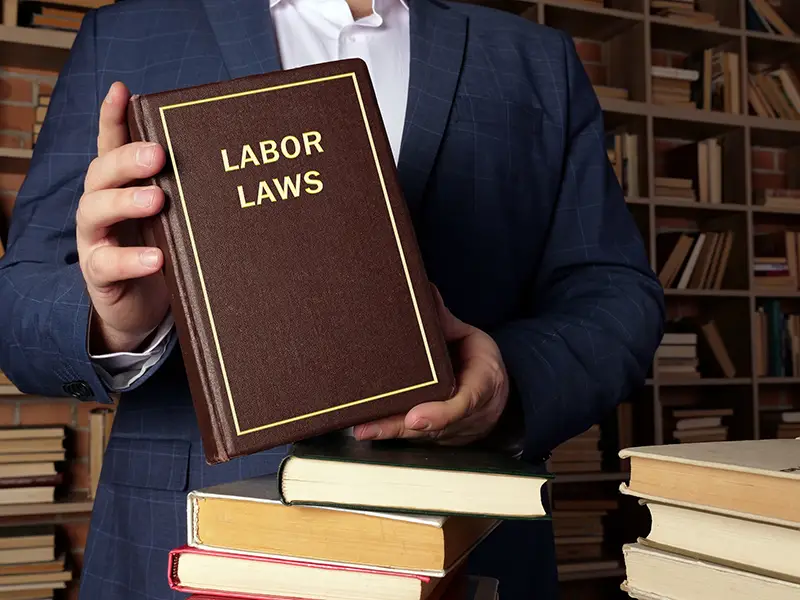 Attorney holding labor laws book