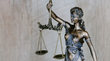 Lady justice wearing a blindfold and holding a sword and scales