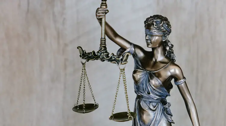 Lady justice wearing a blindfold and holding a sword and scales
