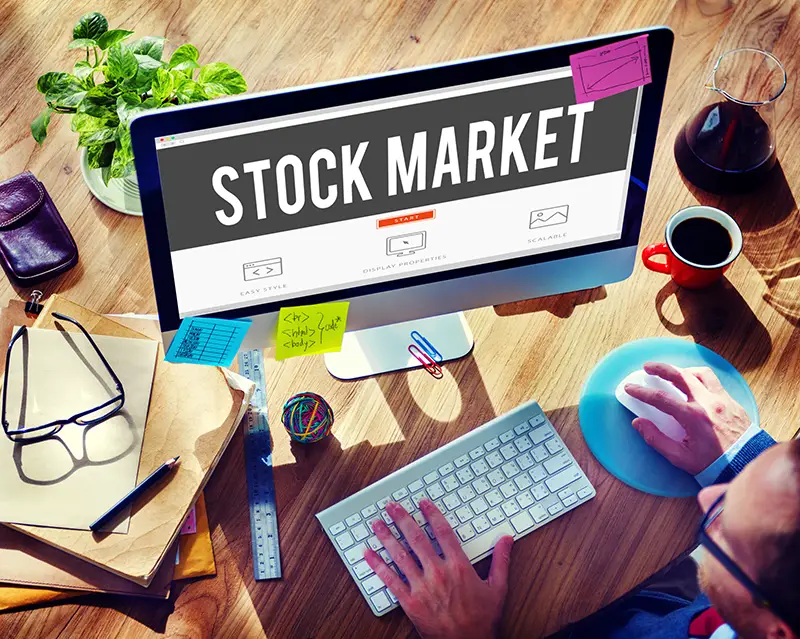 Person in front of computer browsing on stock market