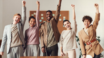 group of professionals raising their hands