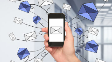 Man sending emails on his mobile phone