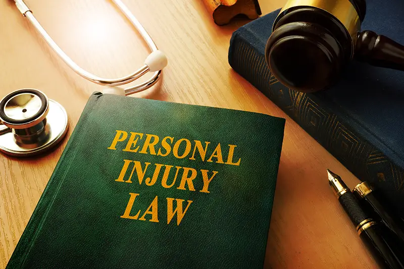 Personal injury law book on the top of brown wooden table