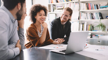 Programmers cooperating at IT company developing apps