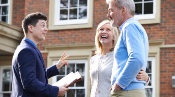 Real estate agent talking to a couple client