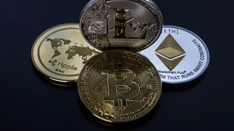 four assorted cryptocurrency coins