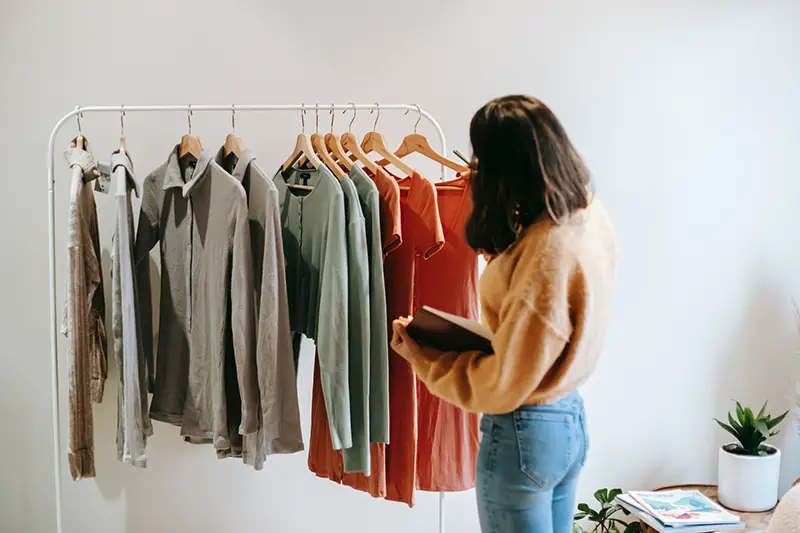 Female seller organizing clothes on hanger
