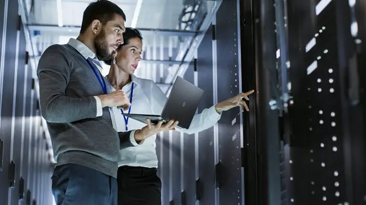IT people working while carrying laptop
