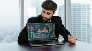 Man in black long sleeves shirt using black laptop computer