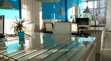Office space with white chairs and glass table