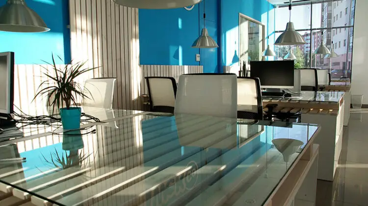 Office space with white chairs and glass table