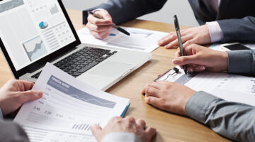 Business professionals working together at office desk