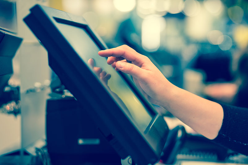 woman hand doing process payment on a touchscreen cash register